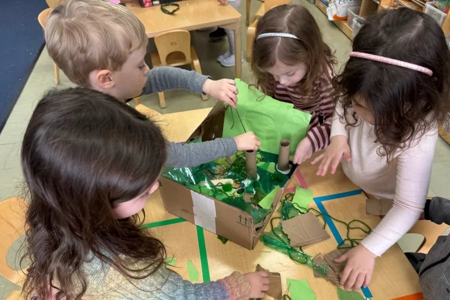 kids building a diorama with recycled materials