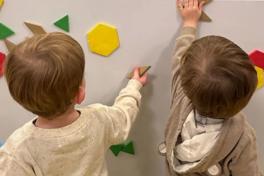 kids playing on a magnet board