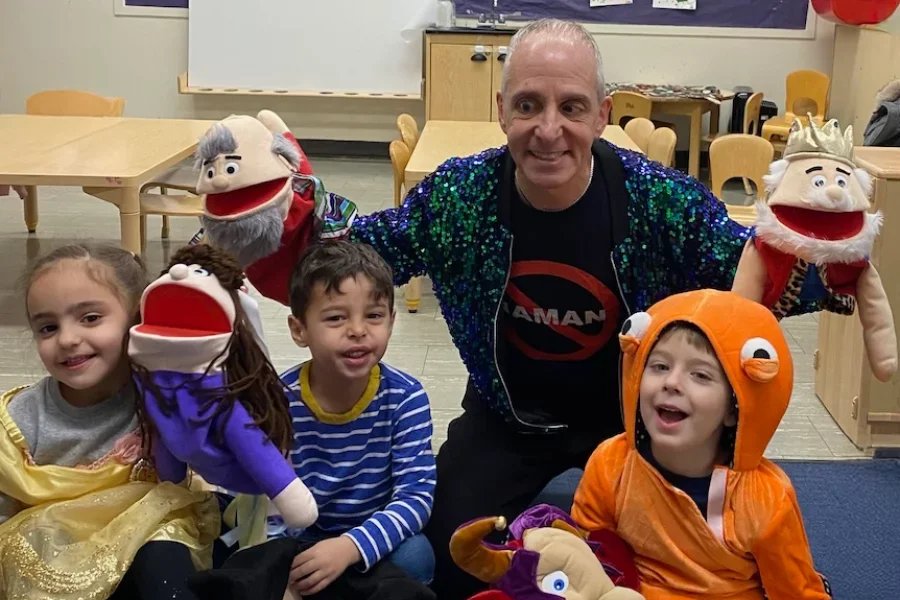 kids and teacher working with puppets