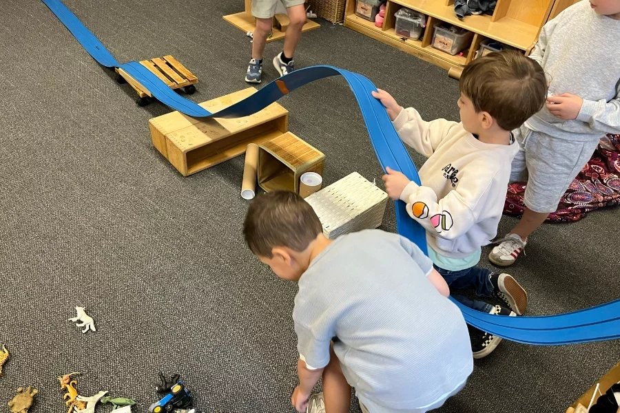 kids building a toy race car track