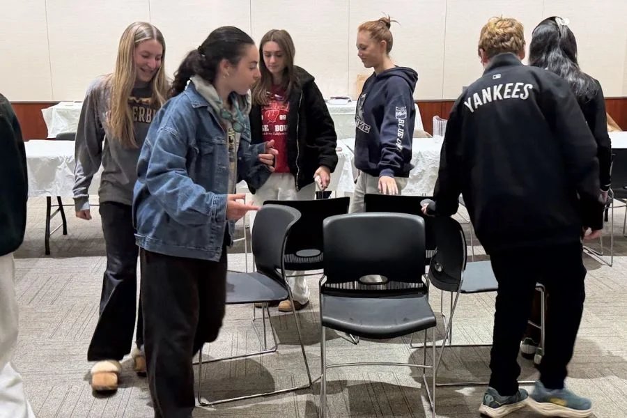 teens shaking the lulav and etrog in sukkah
