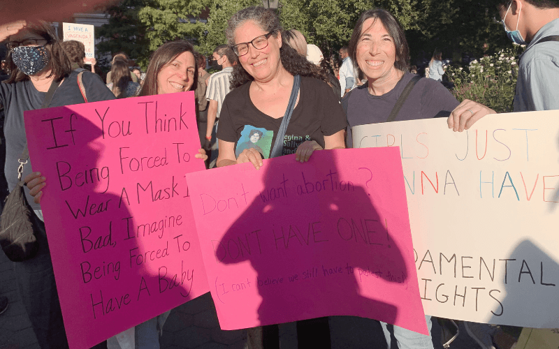 rabbi reines and shaaray tefila members holding signs at a reproductive rights march in 2021