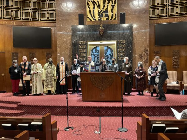 2022 Day of Service Interfaith Thanksgiving Service final benediction by Rabbi Mosbacher with all participating clergy standing on the Bimah